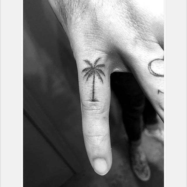 Fine line palm tree tattoo on the wrist