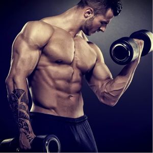 A tattooed guy lifting weights. #weightlifting #muscles #muscularman
