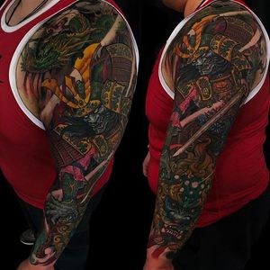 Insane looking sleeve to chest tattoo by Tony Hu. A foo dog, warrior and dragon. #TonyHu #foodog #dragon #warrior