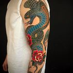 Beautiful and fierce cobra tattoo with roses. Rad work by Graham Beech. #GrahamBeech #NeoTraditional #AnimalTattoos #cobra #roses #sleeve