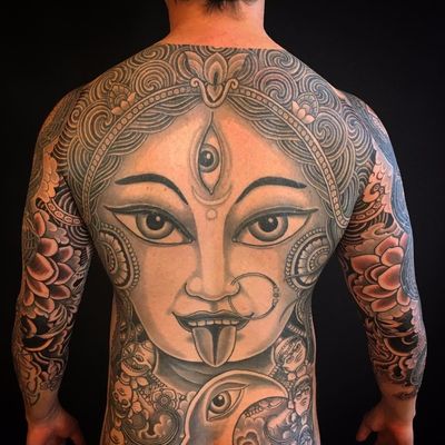Kali back piece by Yoni Zilber #yonizilber #blackandgrey #blackwork #goddesskali #thirdeye #pattern #jewelry #portrait #skulls #moon #clouds #lotus #flowers #waves #Hindu #tibetanskull #tattoooftheday