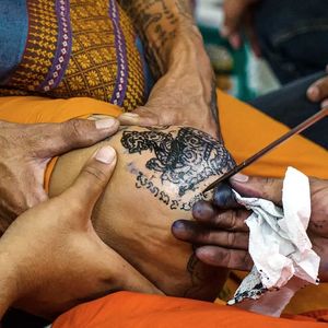 A group of monks tattooing a man with sak yant the night before the Wai Kru festival. Photo by Matthew Karsten #festival #KhongKhuen #sacredtattoos #sakyant  #Thai #WaiKru