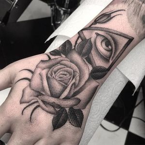Rose and all seeing eye hand tattoo by Diletta Lembo. #neotraditional #blackandgrey #DilettaLembo #handtattoo