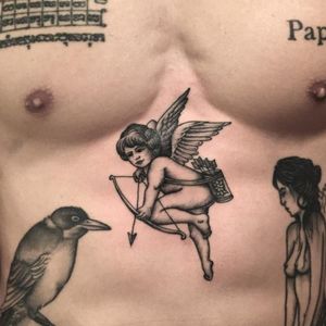 A whimsical black and grey Cupid by Noel C (IG—nolc). #AlliedTattoo #blackandgrey #Cupid #NoelC #NYCtattooshops