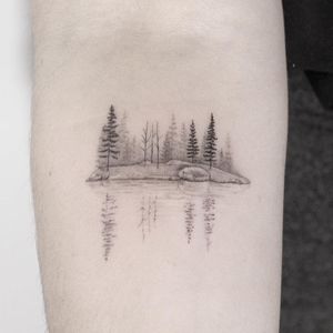 Minimal landscape tattoo by Lindsay April #LindsayApril #lindsayapriltattoo #landscapetattoo #fineline #minimal #blackandgrey #small #landscape #reflection #trees #forest #sea #lake #nature