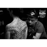 Shot of Ilya Cancad Kanaurov working a new tattoo with one of recurrent clients. Who wouldn't come back to this master of illusion? #backpiece #blackandgrey #geometric #IlyaCancadKanaurov #opticalillusion #ornamental #shading #stippling