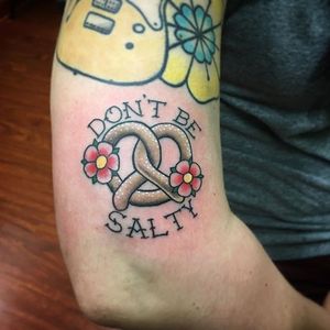 Pretzel and flowers tattoo by Chris Thayer. #dontbesalty #pretzel #flowers #lettering #ChrisThayer