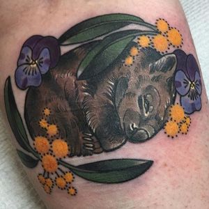Sleepy wombat tattoo by Tan Van Den Broek. #neotraditional #wattle #australiananimal #australianfloral #australianfauna #Australia #wombat #flower #TanVanDenBroek