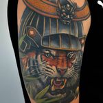Amazing and fierce tiger head tattoo wearing a samurai's helmet. Tattoo by Jaroslaw Baka. #jaroslawbaka #neojapanese #neooriental #coloredtattoo #tiger #tora #SamuraiHelmet