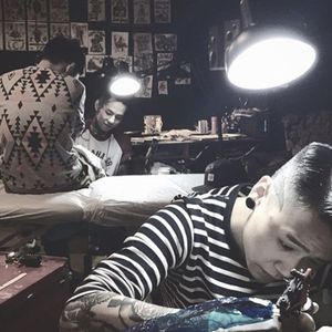 A photograph of Nadi tattooing a client (IG—tattooer_nadi). #abstract #blackwork #freeform #illustrative #Nadi #watercolor