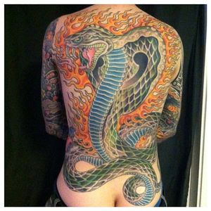 Brilliant cobra back piece tattoo with some flames, masterful tattoo done by Jason Brooks. #JasonBrooks #GreatWaveTattoo #boldtattoos #TraditionalTattoo #cobra #flames