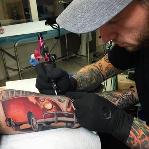 Roger Mares tattooing a VW van on one of his clients (IG—mares_tattooist). #neotraditional #portraiture #RogerMares