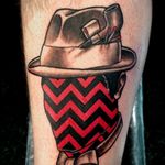 The red and black ink looks striking with the subtle brown shades. Tattoo by Kreatyves #Kreatyves #surreal #geometric #pattern #opticalillusion #redandblack #hat #noface