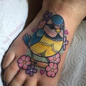 Cute bird and flower foot tattoo by Sam Whitehead. #cute #pastel #bird #flower #SamWhitehead