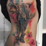 Vibrant elephant and flower watercolor tattoo by Danielle Merricks. #flower #elephant #watercolor #inksplatter #DanielleMerricks