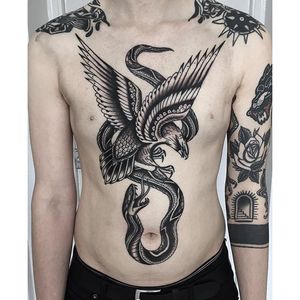 Flawless linework in this torso piece. Tattoo by Aaron Breeze #AaronBreeze #neotraditional #traditional #LifeAndDeathTattoo #blackworker #eagle #snake