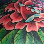 A close up of Scott Garitson's (IG—scottgaritsontattoo) amazing mixture of bold and slight line-work in this flower. #colorful #neotraditional #ScottGaritson #rose