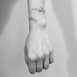 Floral bracelet tattoo by Vitaly Kazantsev. #VitalyKazantsev #flower #floral #bracelet #band #lovely #subtle #fineline
