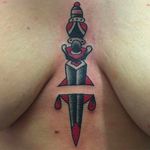 Tough looking dagger tattoo on the sternum. Clean and solid work by Janitor Jake. #JanitorJake #HatCityTattoo #traditional #boldtattoos #dagger #sternumtattoo