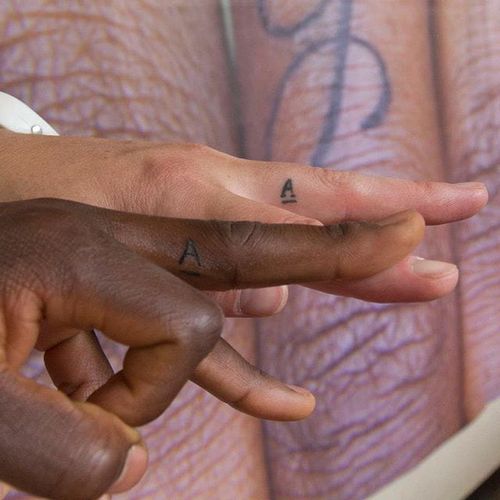 Joseph Hebo and Marlinda Brugmans' finger tattoos via instagram humanrightstattoo #humanrights #humanrightstattoo #lettering #tattooproject #SandervanBussel