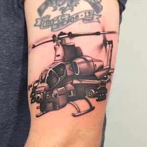 Rad looking battle chopper tattoo done by Nate Graves. #NateGraves #SacredTattoo #michigan #blackandgrey #realistic #helicopter #chopper