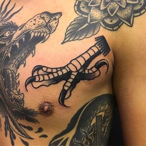 Clean and solid chest tattoo of a talon by Wilson Ng. #WilsonNg #BoldTattoos #traditionaltattoo #talon #claw #traditional