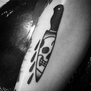 Rad knife tattoo with a skull. Nice composition by Kyle Lifetime. #KyleLifetime #blacktattoos #traditionaltattoo #knife #skull