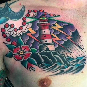 A lonely lighthouse shining out from a thunderstorm by Filip Henningsson (IG—rdtattoofilip). #FilipHenningsson #flower #lighthouse #seascape #storm #traditional