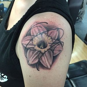 A black and grey realism daffodil really pops with these fineline swirls. Tattoo by Stephen Nance. #daffodil #blackandgrey #realism #StephenNance #lower