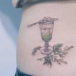 Absinthe tattoo by Baam Kr #Baamkr #Baam #illustrativetattoos #fineline #watercolor #painterly #drawing #watercolor #realism #realistic #absinthe #sugar #floral #leaves #nature #glass #goblet #crystal