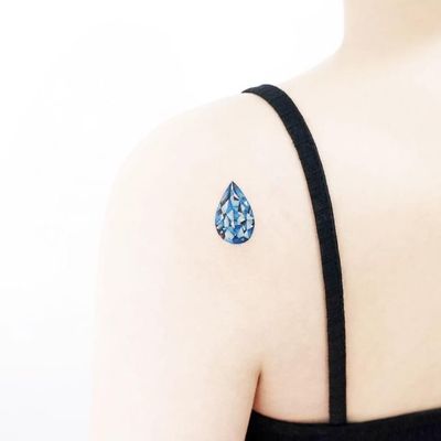 Tear drop jewel tattoo by Tattooist Ida #TattooistIda #Ida #jeweltattoos #color #realism #realistic #hyperrealism #teardrop #blue #jewel #gem #crystal #watercolor #tattoooftheday
