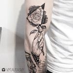 Hand holding a rose tattoo by Vytautas Vy. #VytautasVy #blackwork #rose #dotwork #contemporary #alternative