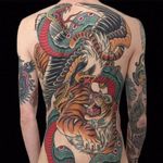 Ancient Rivalries in Backpiece form by Gordon Combs #GordonCombs #color #traditional #backpiece #snake #fangs #eagle #bird #feathers #baldeagle #bird #tiger #junglecat #cat #fight #tattoooftheday