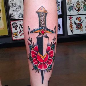 Classic looking dagger through the rose. Tattoo by Douglas Grady. #DouglasGrady #traditionaltattoo #coloredtattoo #brightandbold #dagger #rose