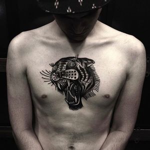 Tiger head chest tattoo by Andre Albuquerque. Photo: @albvquerque #andrealbuquerque #black #traditional #tiger #tigerhead