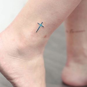 Subtle tattoo by Anzo Choi. #subtle #microtattoo #pastel #southkorean #feminine #girly #tiny #cross