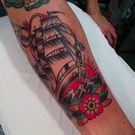 Beautiful and clean galleon tattoo with a classic looking blossom. Tattoo by Eddie Czaicki. #eddieczaicki #galleon #ship #traditionaltattoo #blossom