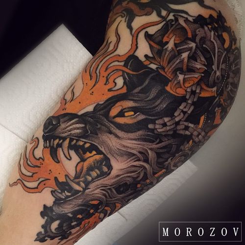 Wolf head tattoo by Vitaly Morozov #VitalyMorozov #darkarttattoos #color #neotraditional #fire #flames #death #dog #wolf #chains #biomechanical #medieval #tattoooftheday