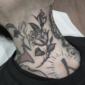 Neck rose tattoo by Gianluca Fusco #GianlucaFusco #flowertattoos #blackandgrey #oldschool #traditional #rose #rosebud #leaves #nature #flowers #floral #necktattoo #tattoooftheday