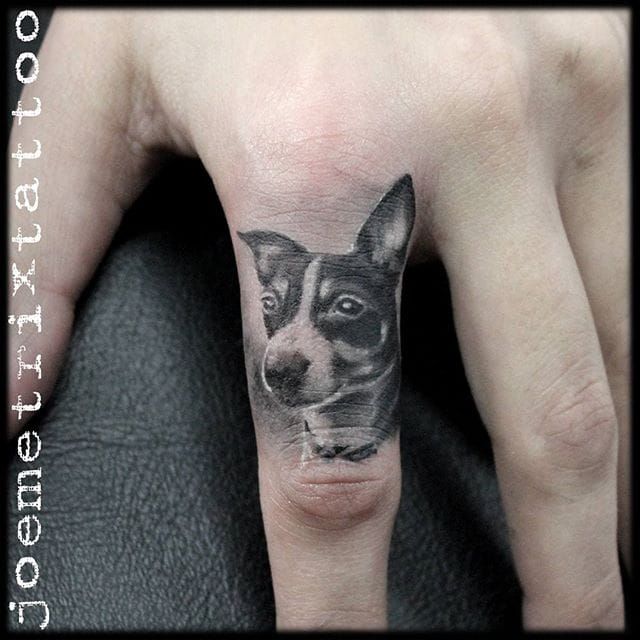 Minimalist dog paw tattoo on the finger