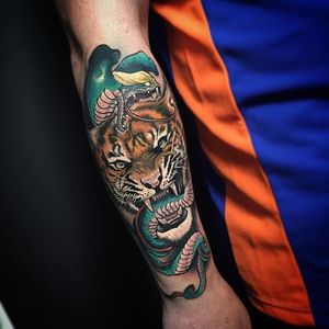 An aggressive tiger and cobra tattoo by Fabz. #tiger #snake #cobra #neotraditional #Fabz @TheBlackMark