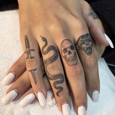Finger tattoos by Ben Grillo #BenGrillo #blackandgrey #whiteink #traditional #small #sword #knife #snake #reptile #animal #nature #skull #bones #death #panther #junglecat #cat #tattoooftheday