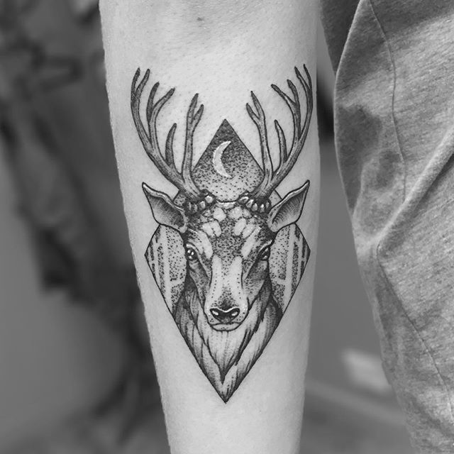 Continuous line deer tattoo on the inner forearm.