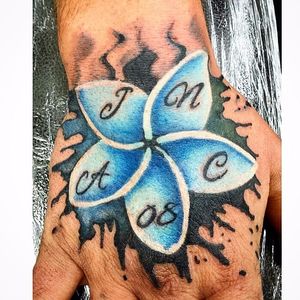 Bright Blue Frangipani Tattoo with Initials by Mark Edwards #frangipani #plumeria #MarkEdwards #handtattoo #hand #initials #flower