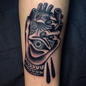 Solid tattoo of a hand holding an anatomical heart with an eye. Bizarre tattoo by Rodrigo Garcia Delgadillo. #rodrigogarciadelgadillo #hand #heart #eye
