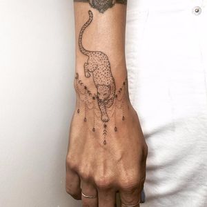 Delicate wrist cat by Tati Compton #TatiCompton #blackwork #linework #stickandpoke #dotwork #leopard #junglecat #cat #ornamental #pattern #stars #moon #raindrops #linework #tattoooftheday