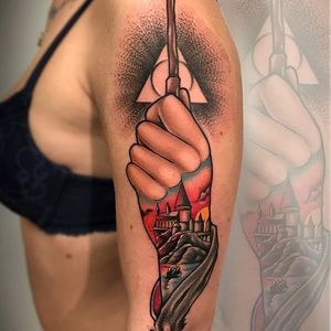 Hogwarts tattoo within a tattoo by Fulvio Vaccarone. #FulvioVaccarone #traditional #wand #deathlyhallows #HarryPotter #hogwarts #castle #popculture #film #tattooedtattoo