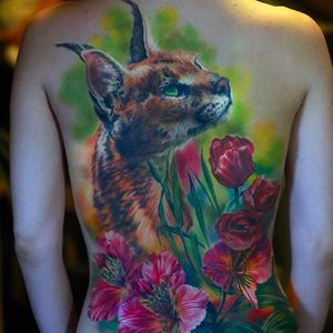 Massive and beautiful bobcat tattoo with some flowers. Tattoo by Nika Samarina. #nikasamarina #coloredtattoo #surrealtattoo #organic  #bobcat #floral