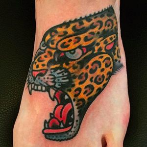 Leopard head tattoo on foot done by Alex WIld. #AlexWild #traditionaltattoo #boldtattoos #leopard #leopardhead