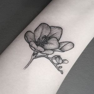 Miniature dotwork freesia tattoo by Fliquet Renouf. #dotwork #blackwork #flower #freesia #FliquetRenouf